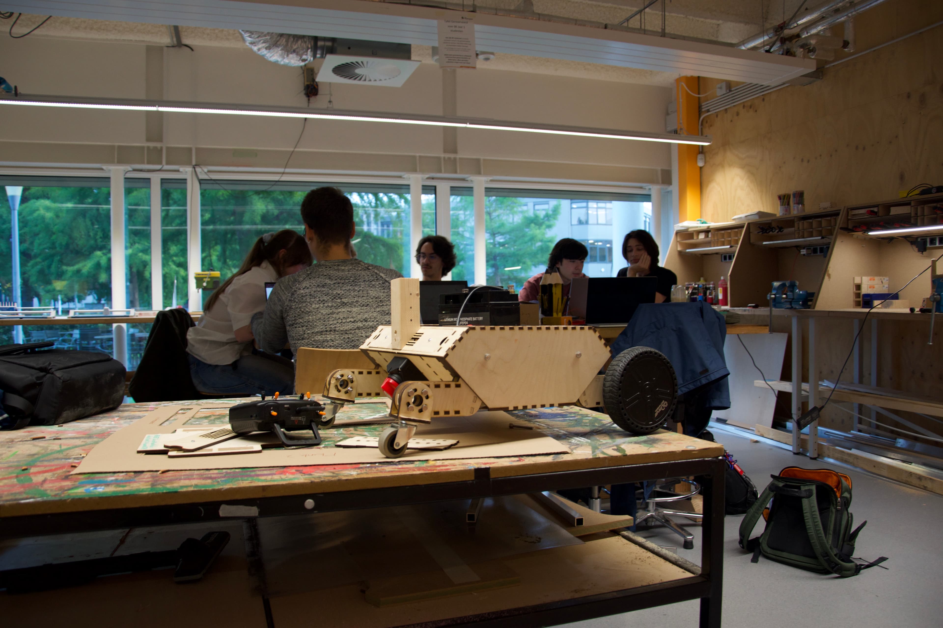 Members working on a wooden rover in the GEARS workshop